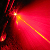 A random laser flash of light. A random laser (red) shines light in all direction while it is pumped by a standard unidirectional laser (yellow).