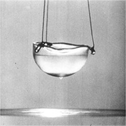 Superfluid helium escaping its container. One of the most remarkable manifestations of superfluidity is that superfluid helium can move up the inside walls of a container in a thin film, run down on the outside walls and finally form drops, which help it to escape into the liquid below.