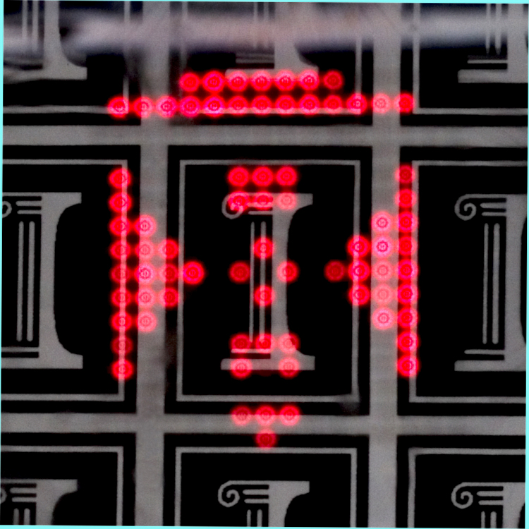Transparent ILED display. The transparent micro-ILED array is placed in front of the logo pattern of the University of Illinois at Urbana-Champaign (USA).