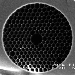 A hollow-core photonic crystal fiber (PCF). Scanning electron microscope (SEM) image of the cross-section of a hollow-core PCF. Most of the light is transmitted in the hollow-core.